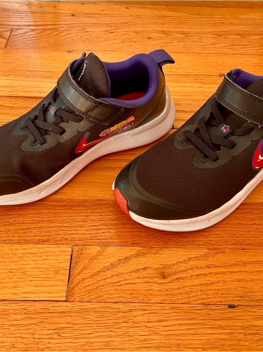Nike Kids Black Sneakers with Red Swoosh and Purple Lining